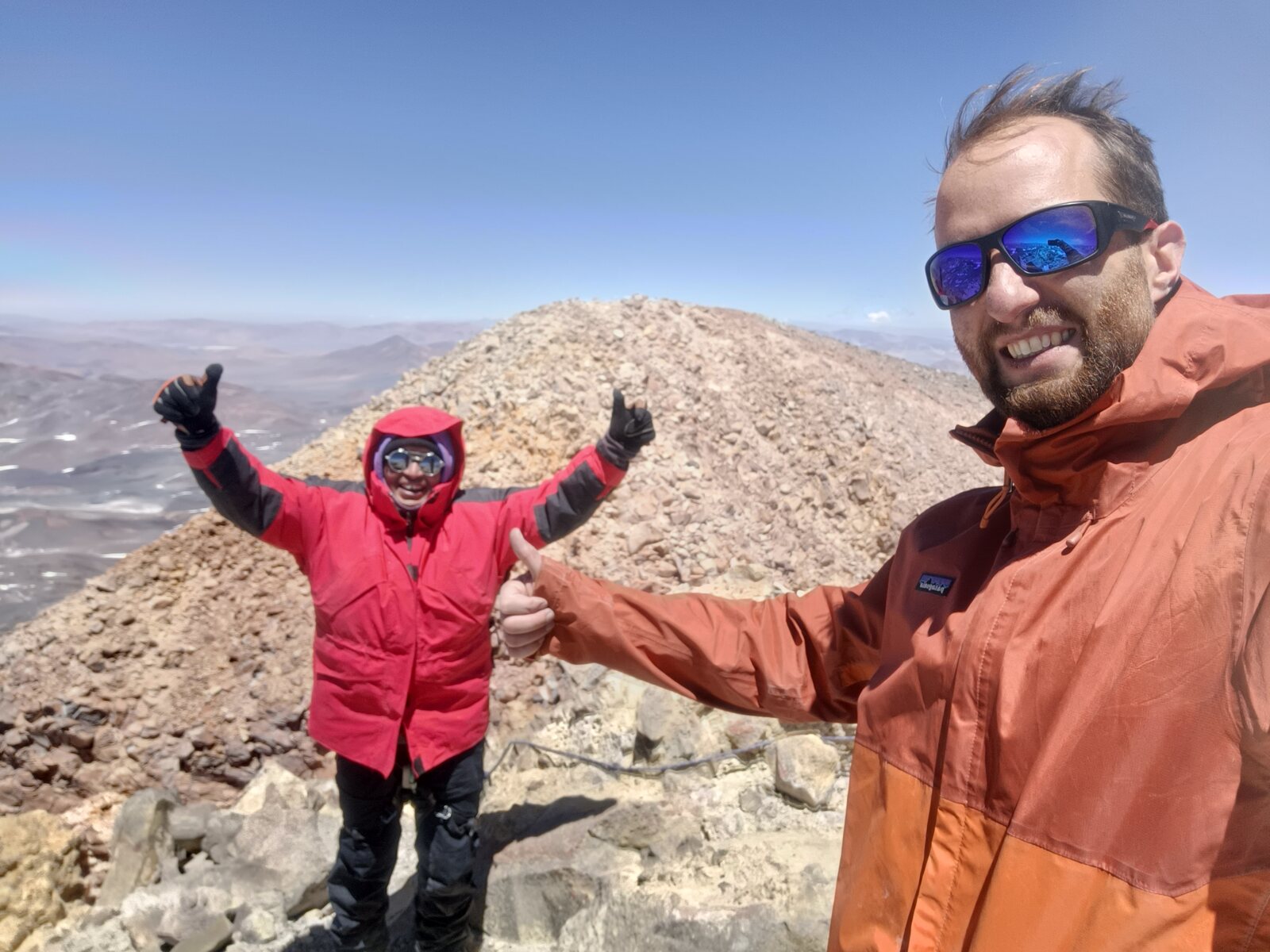 Arms up with the guide, just below the summit